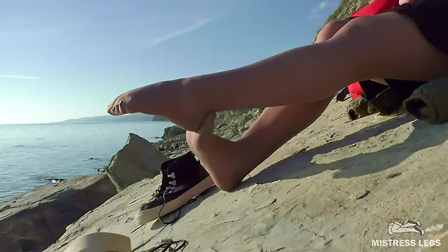Sexy Feet In Flesh-colored Pantyhose On Autumn Seashore