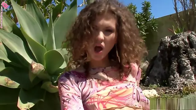 Ravishing brunette with curly hair plays with her tight pussy in the Garden of Eden