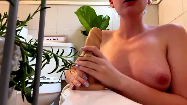 Sage gives a sloppy blowjob to a 8 dildo in the tub